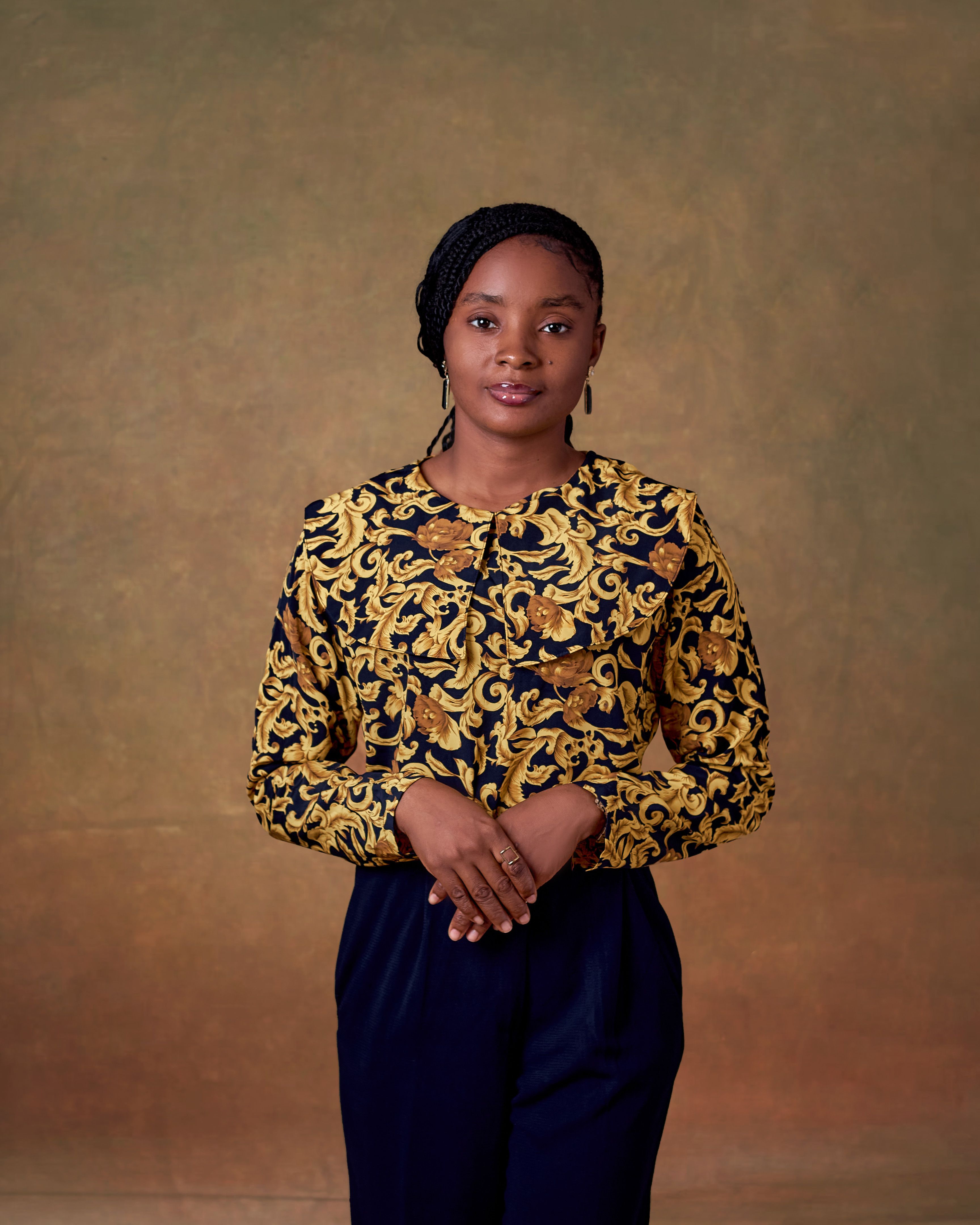 Portrait of a woman wearing elegant traditional attire, set against a classic backdrop.