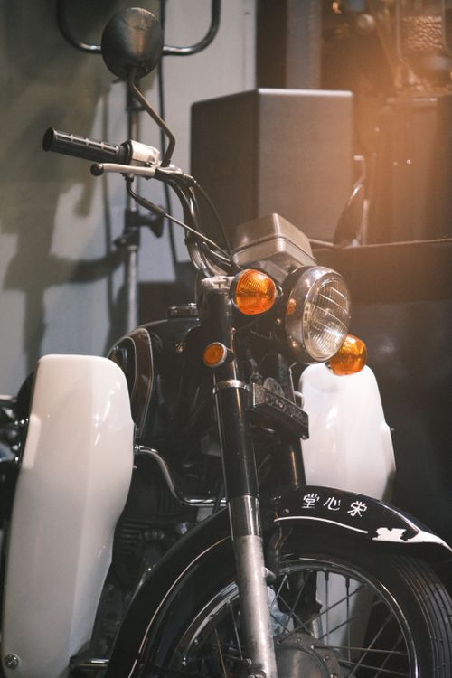 Free Classic vintage motorcycle parked indoors with retro styling and chrome details. Stock Photo