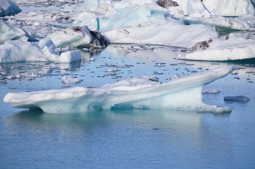Free Stunning icebergs float peacefully in the serene waters of Iceland's Þingeyjarsveit region. Stock Photo