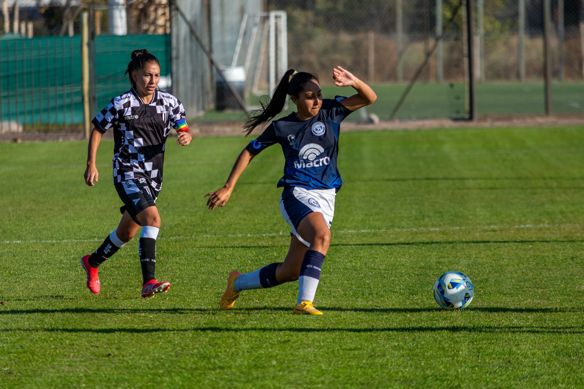 women’s football team performing a scanning and receiving drill with numbered cones under evening floodlights