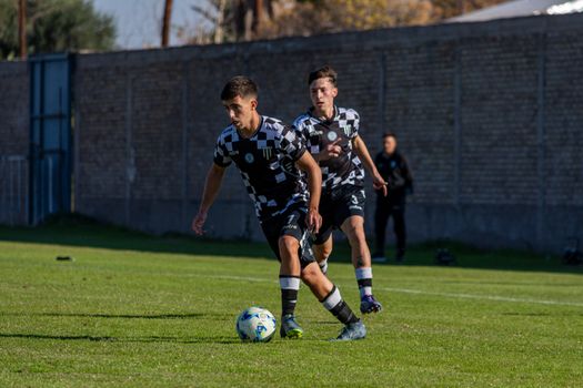 Dynamic shot of soccer players competing during a match outdoors.