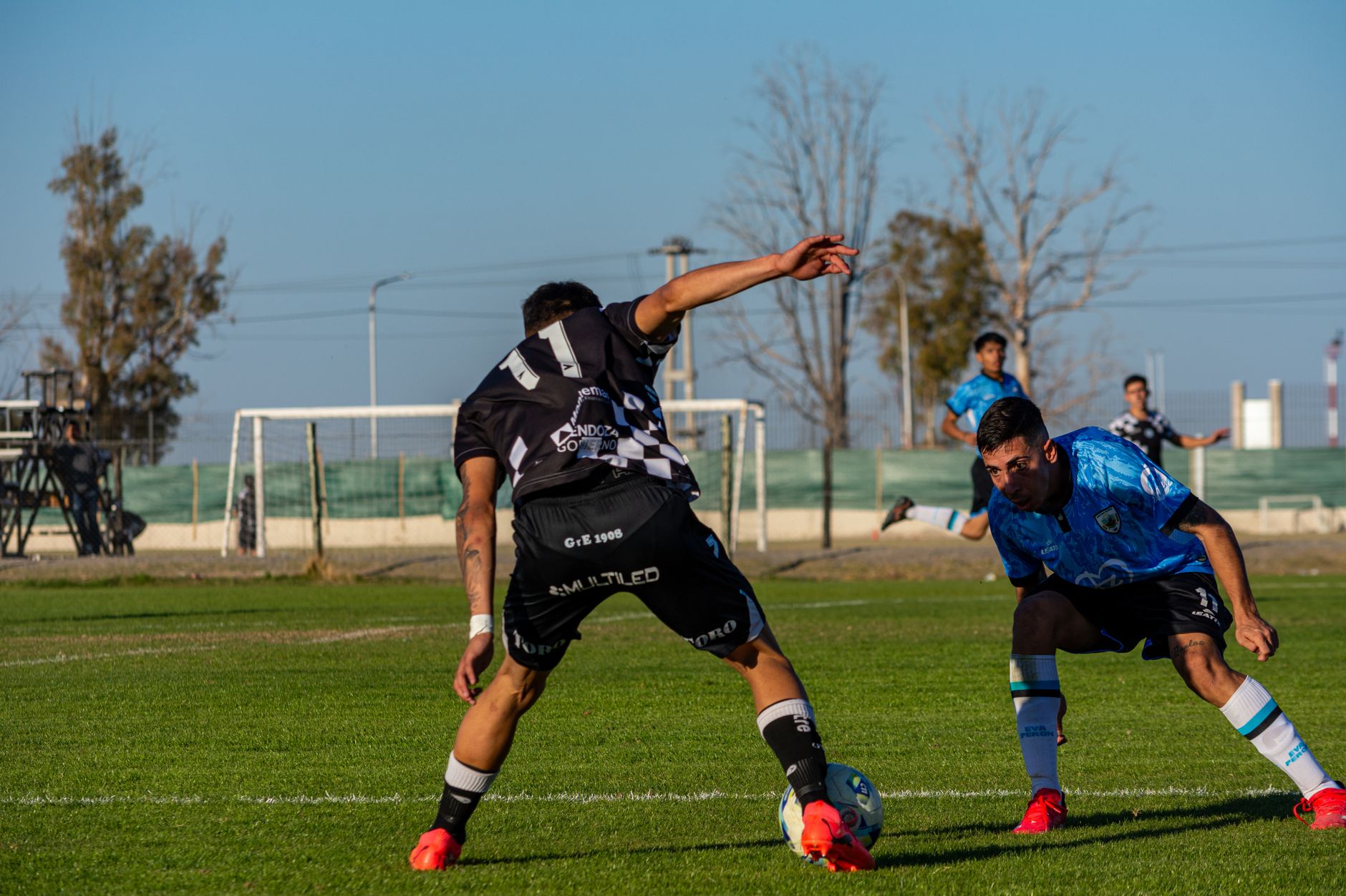 Captured intense moment during a soccer match under clear skies.