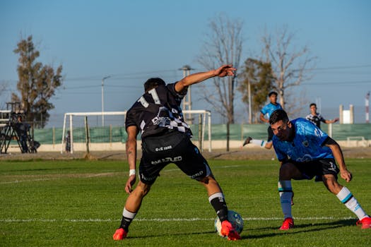 Captured intense moment during a soccer match under clear skies.