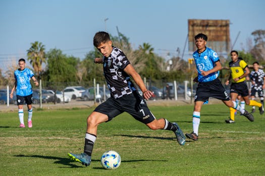 Energetic soccer match with young athletes in action on a bright and sunny day outdoors.