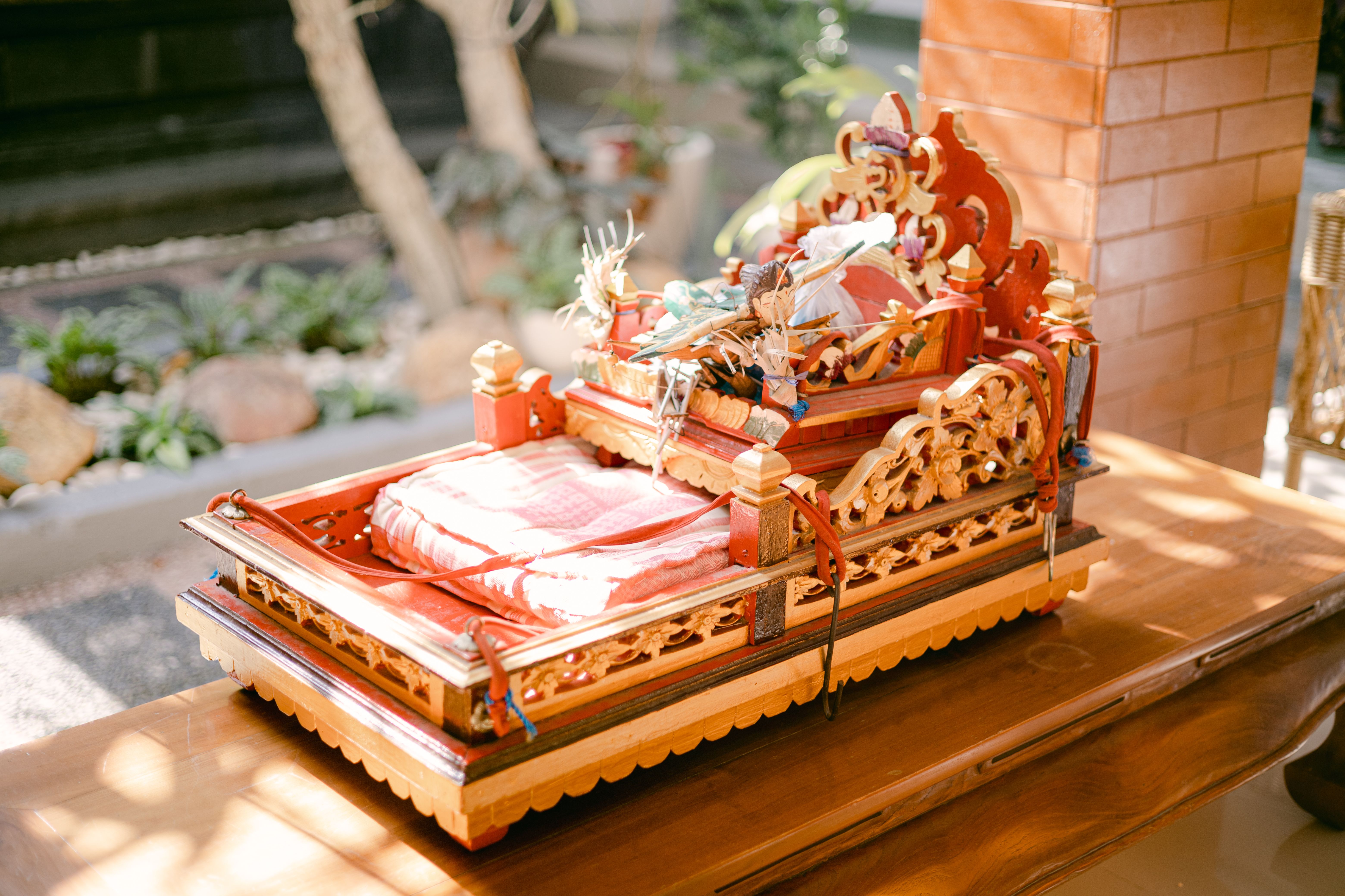 Beautifully crafted Balinese offering table with decorative elements in a serene outdoor setting.