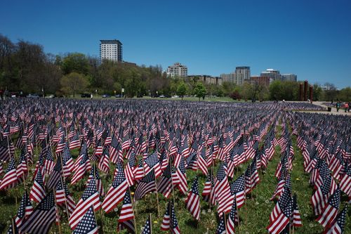 Free A vast field of American flags honors Memorial Day in a city park. Stock Photo