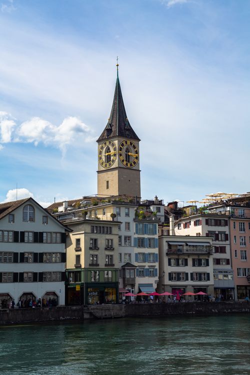 Free View of St. Peter Church tower and Limmat River in Zürich, Switzerland. Stock Photo