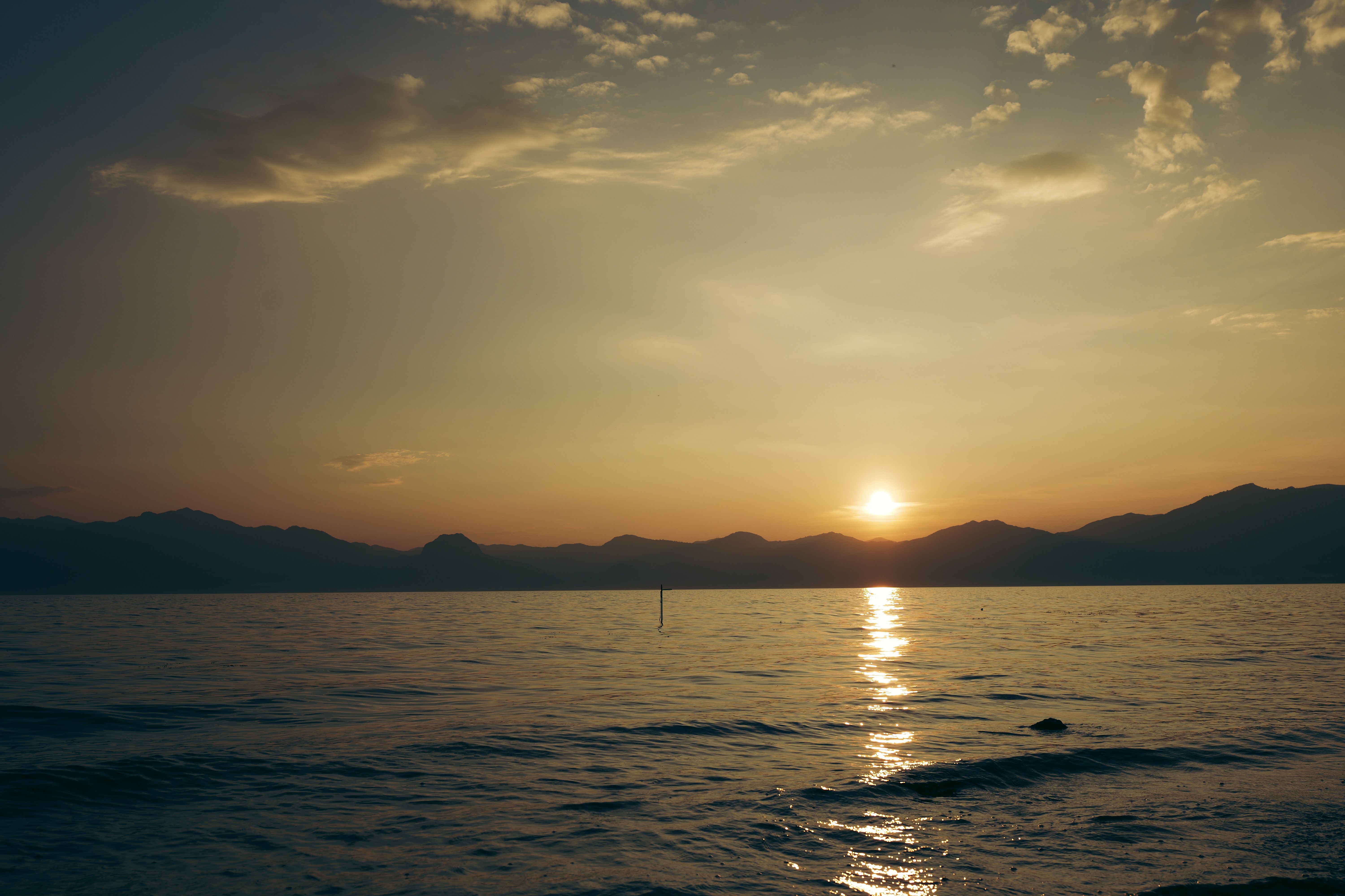 Serene Sunset Over Tranquil Mountain Lake · Free Stock Photo