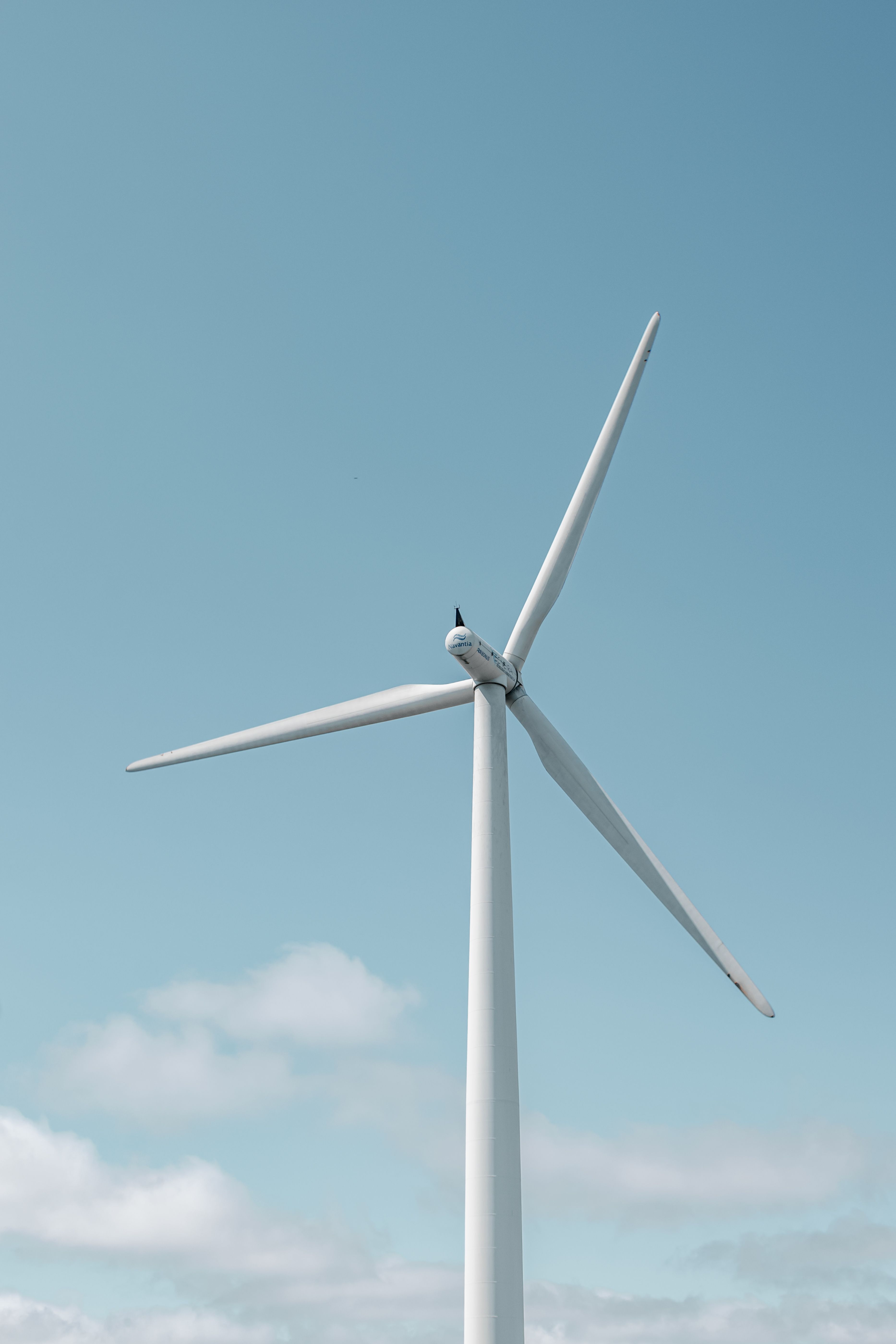 Modern Wind Turbine Against Clear Blue Sky · Free Stock Photo