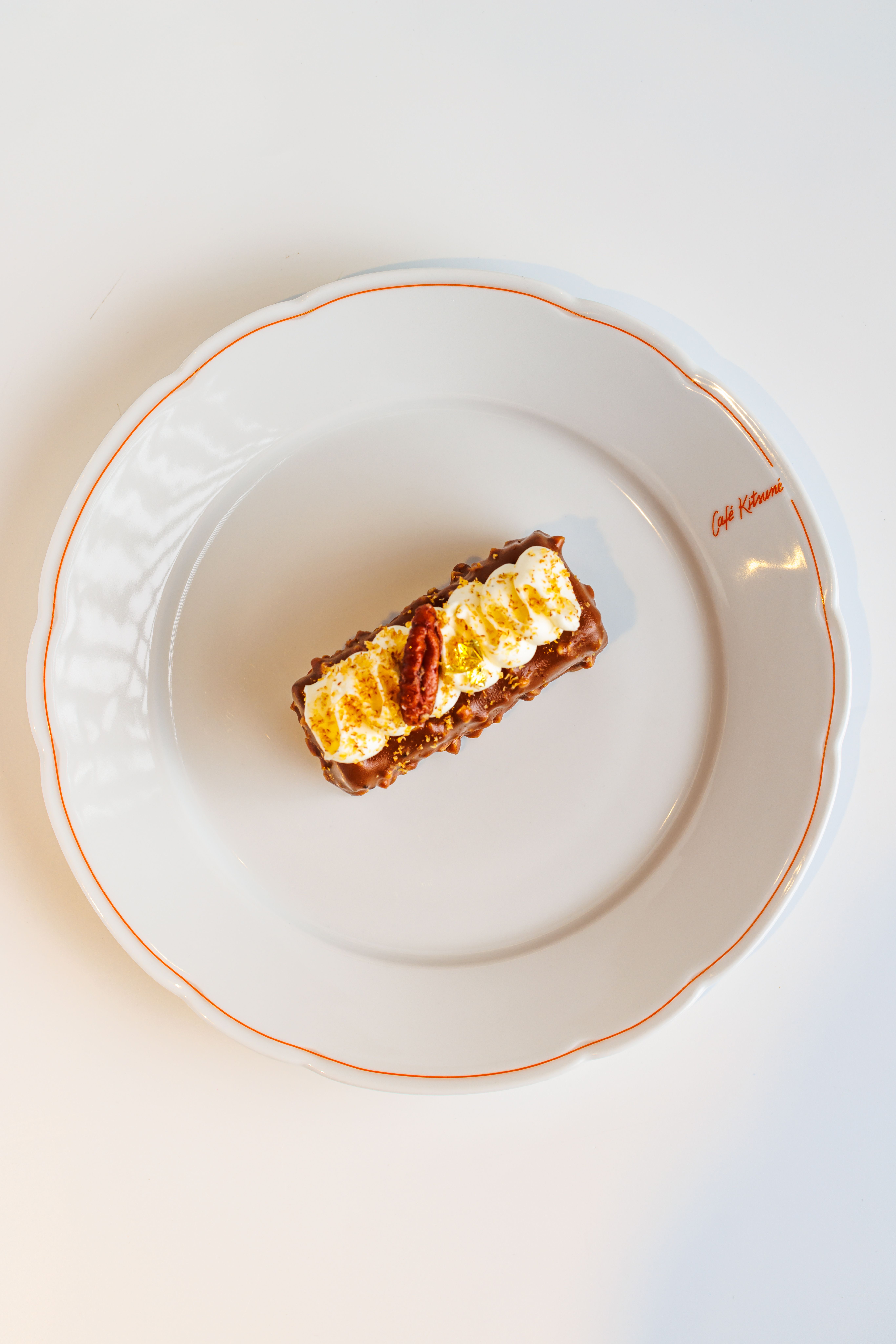 A pan of Neiman Marcus cake bars dusted with powdered sugar, cut into squares showing a golden pecan crust and a dense gooey cream cheese layer.