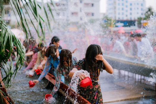 Vibrant scene of people enjoying a water festival in Chittagong, Bangladesh.