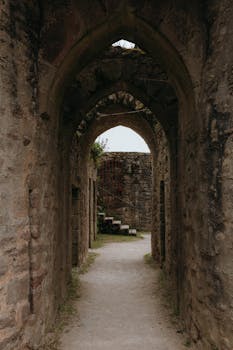 Ancient stone corridor of a castle in Clisson, France, showcasing historic architecture.