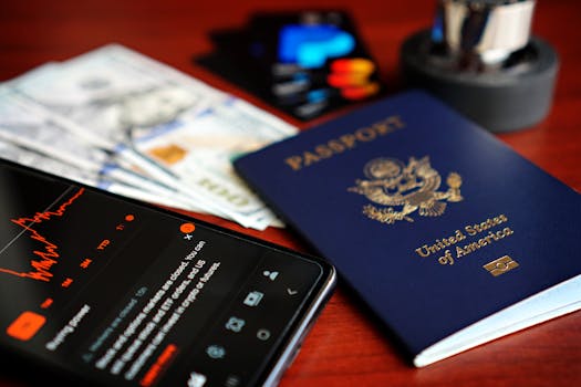 Colorful display of travel essentials including US passport, currency, and smartphone.