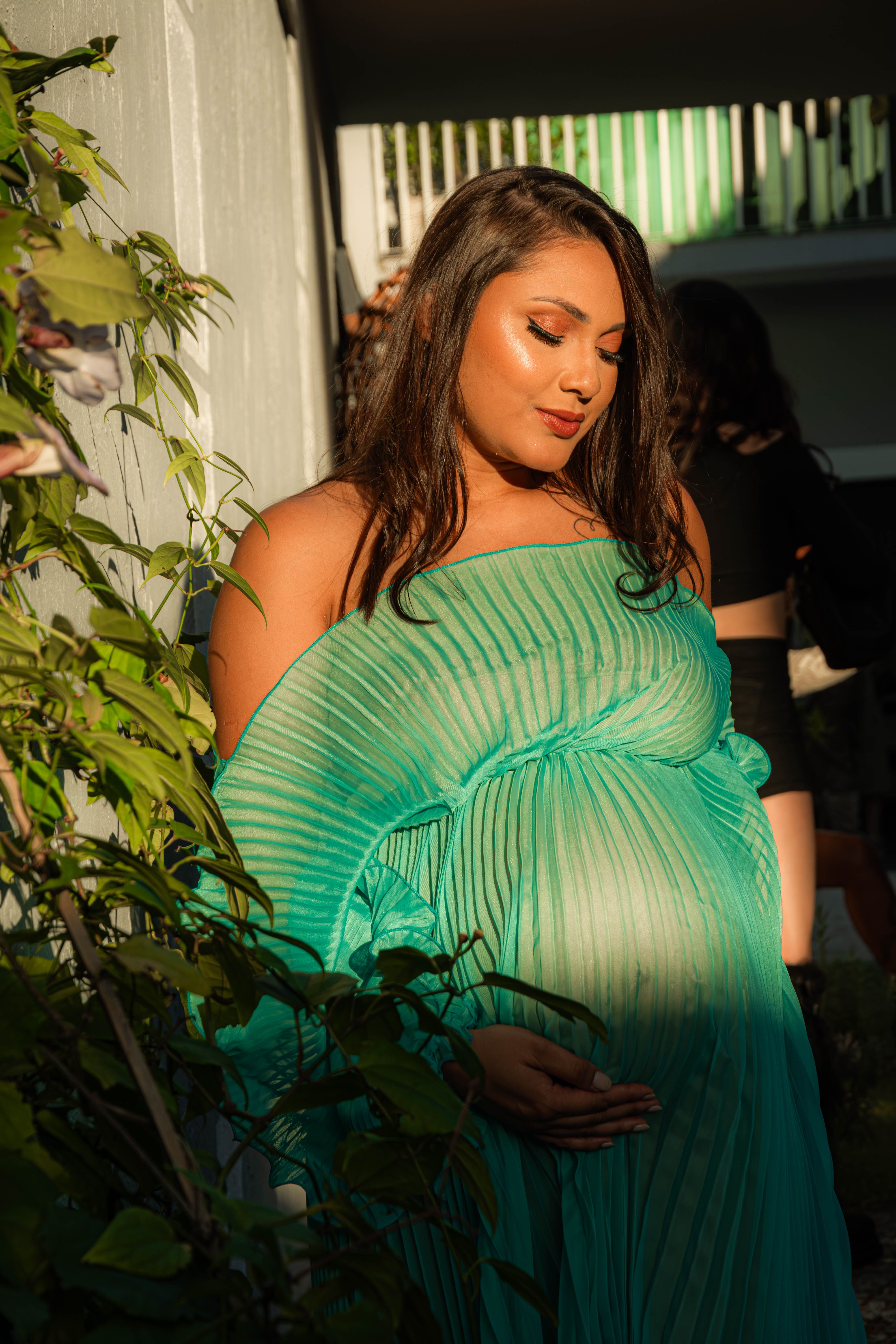 Pregnant Woman in Green Dress in Sunlit Garden · Free Stock Photo