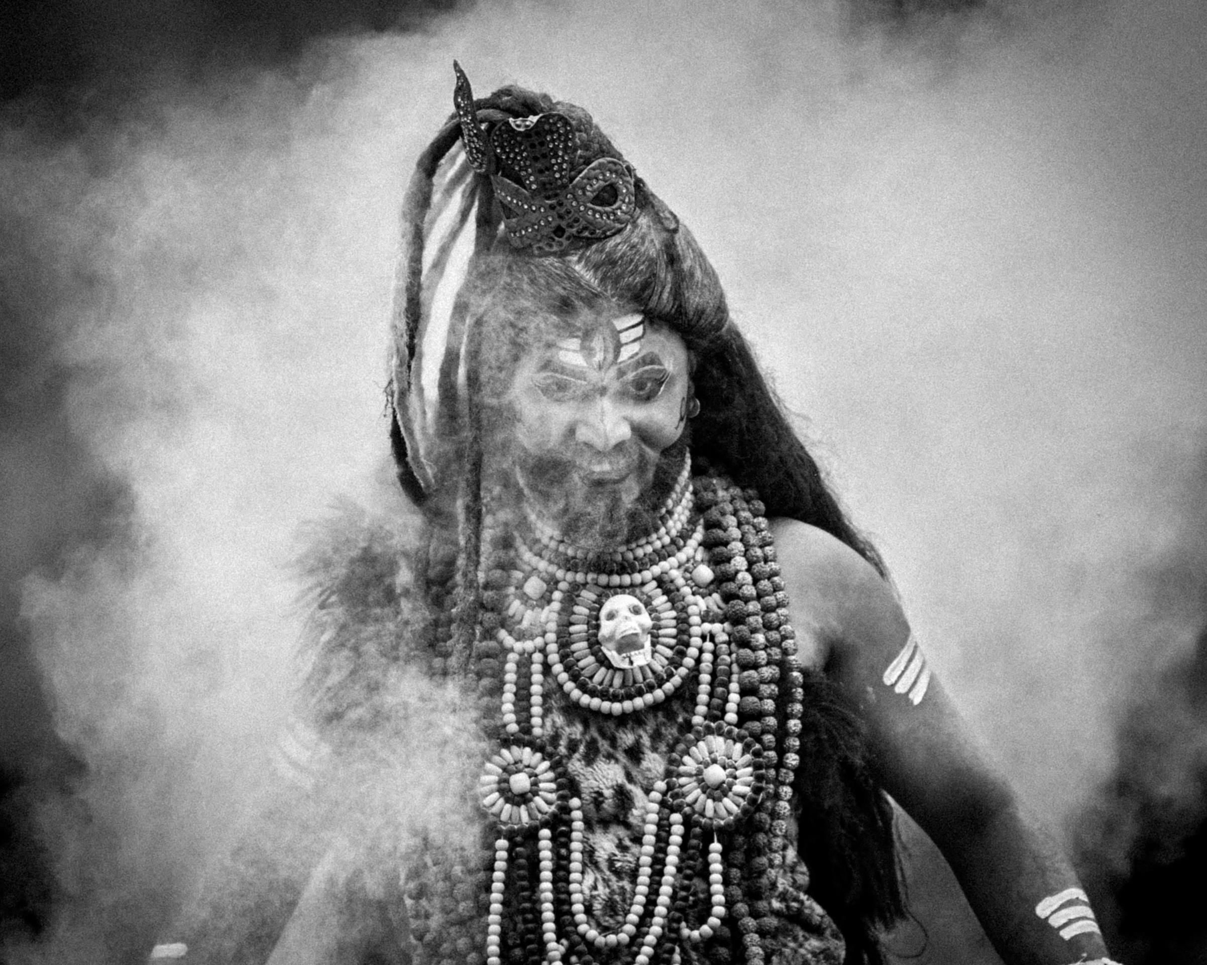 Free A striking black and white photo of a traditional performer enveloped in smoke. Stock Photo