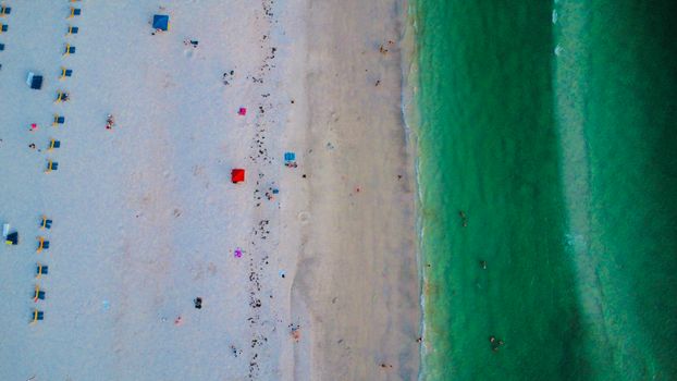 Explore the stunning aerial view of a sandy beach and vibrant green ocean waves.