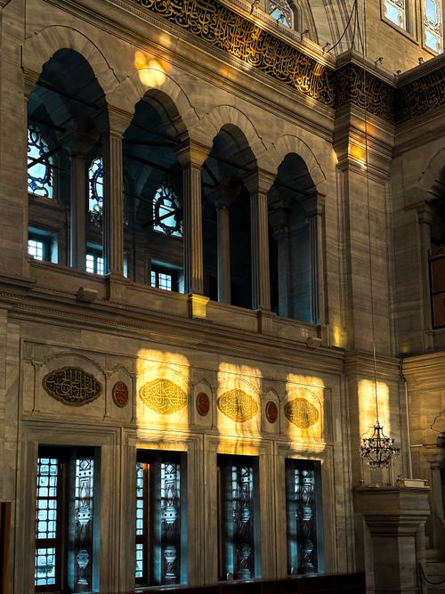 Free Sunlight illuminating ornate interior arches and windows of a historic mosque. Stock Photo