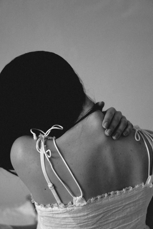 Free Elegant black and white photo capturing a woman's back in an artistic pose. Stock Photo