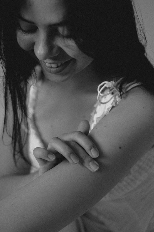 Free A joyful woman smiling in a candid black and white portrait Stock Photo
