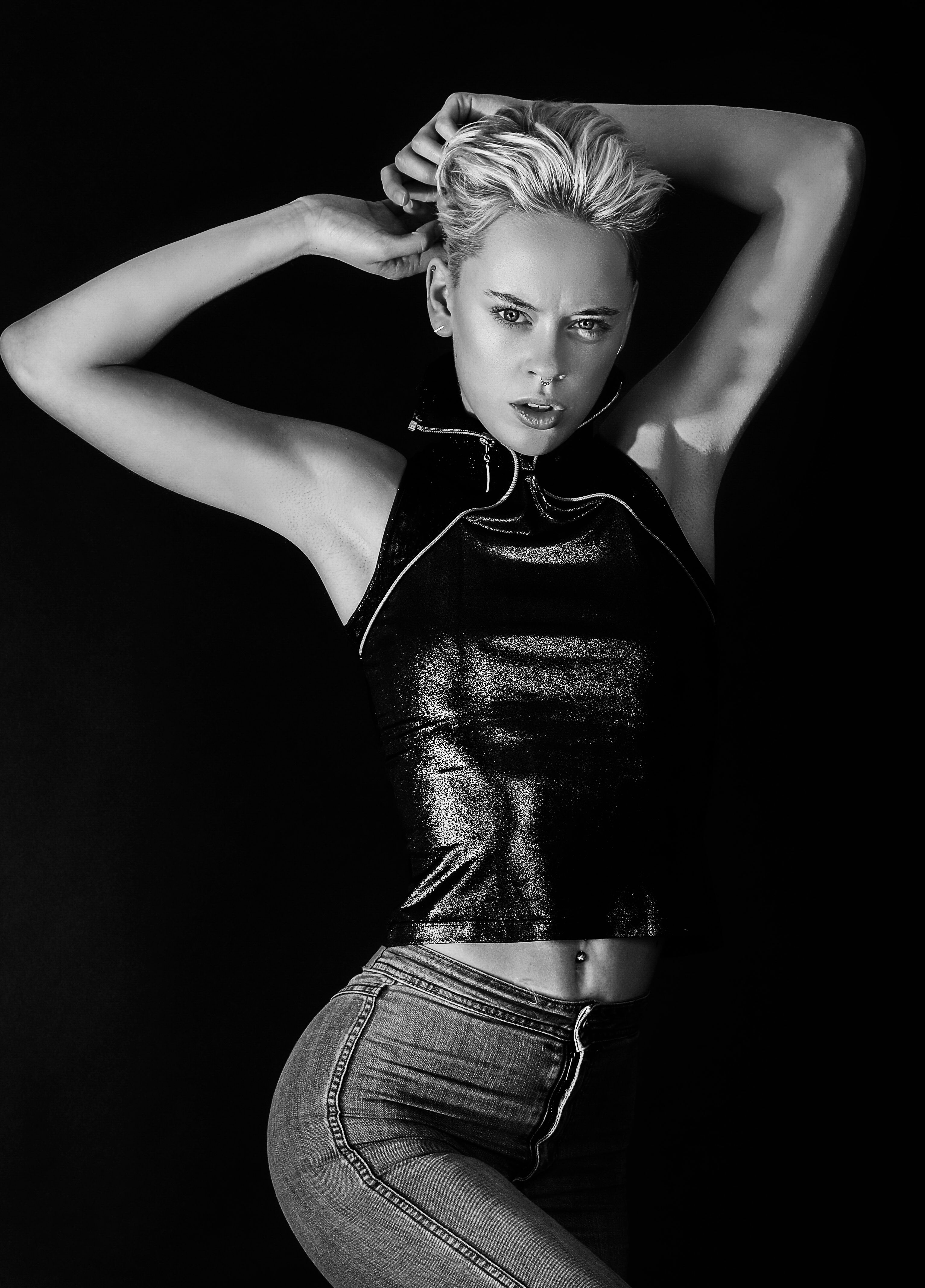 Striking black and white portrait of a stylish woman posing in fashionable attire.