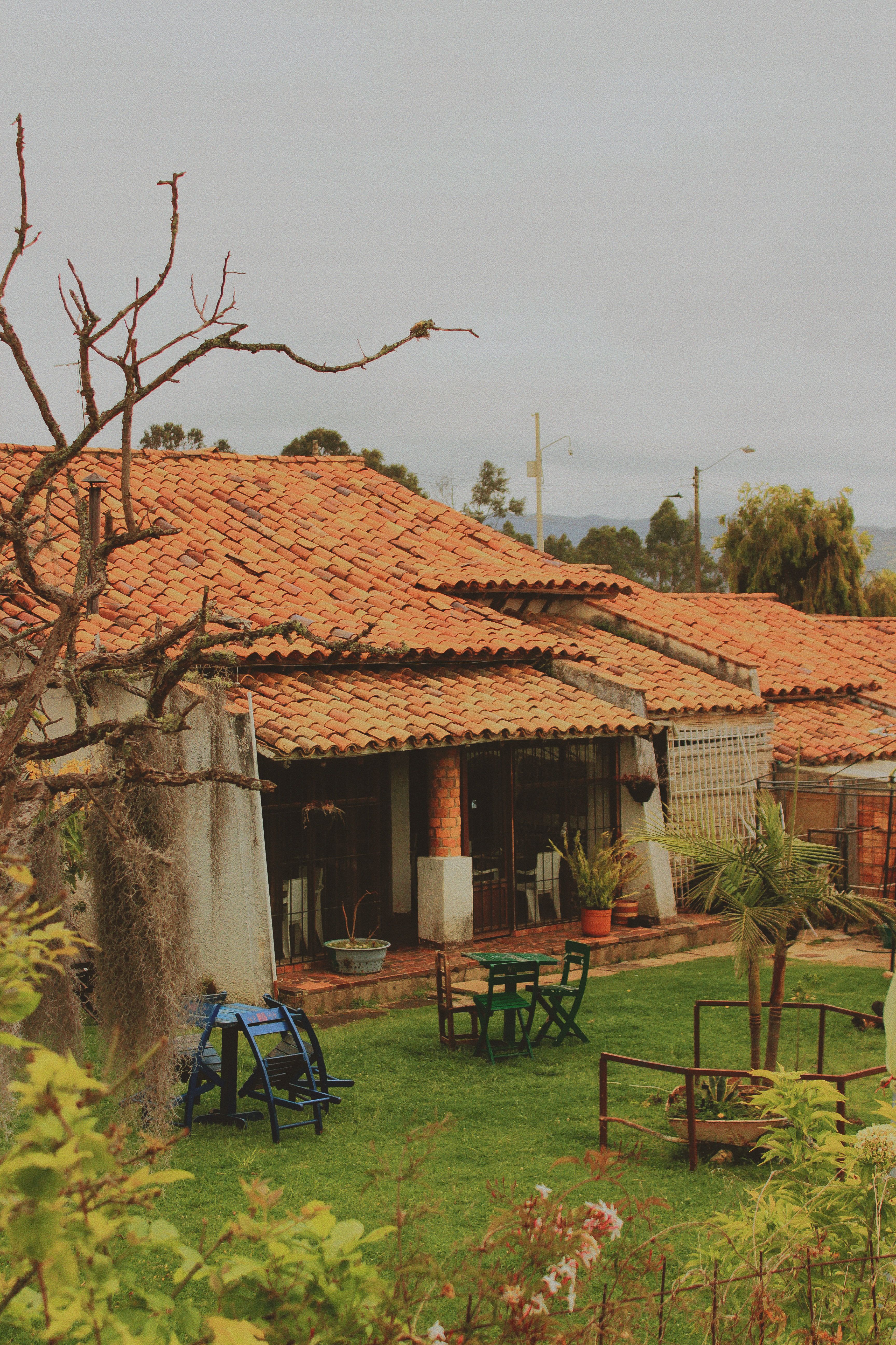 Charming Rustic House with Clay Roof in Garden Setting · Free Stock Photo