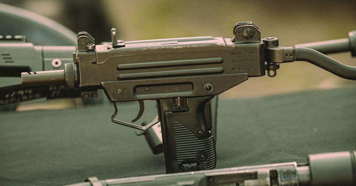 Cropped Gun Close-Up of Submachine Gun on Display Table · Free Stock Photo