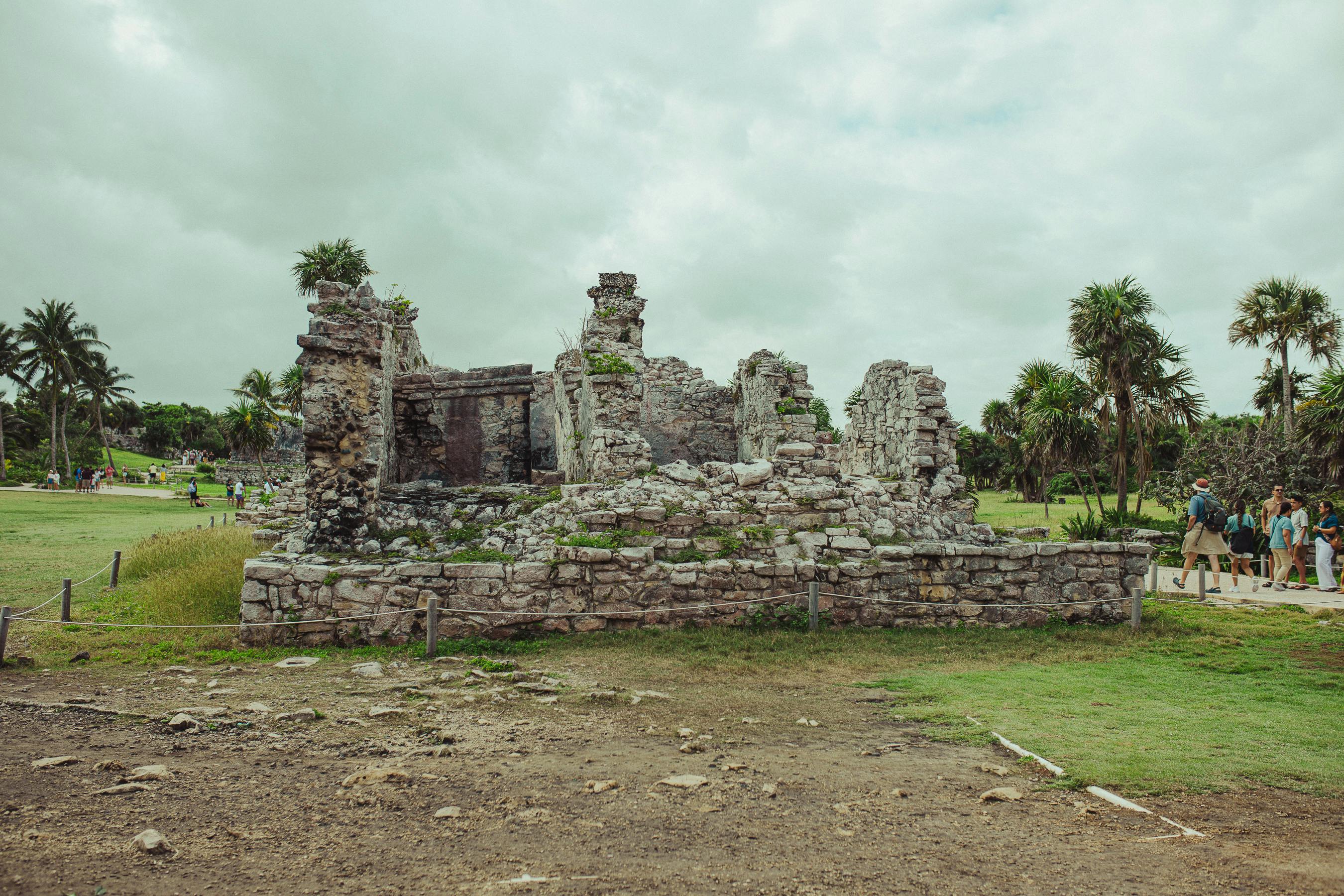 best time of year to visit mayan ruins - Explore the ancient Mayan ruins in Tulum, Mexico, set against lush greenery and a cloudy sky.