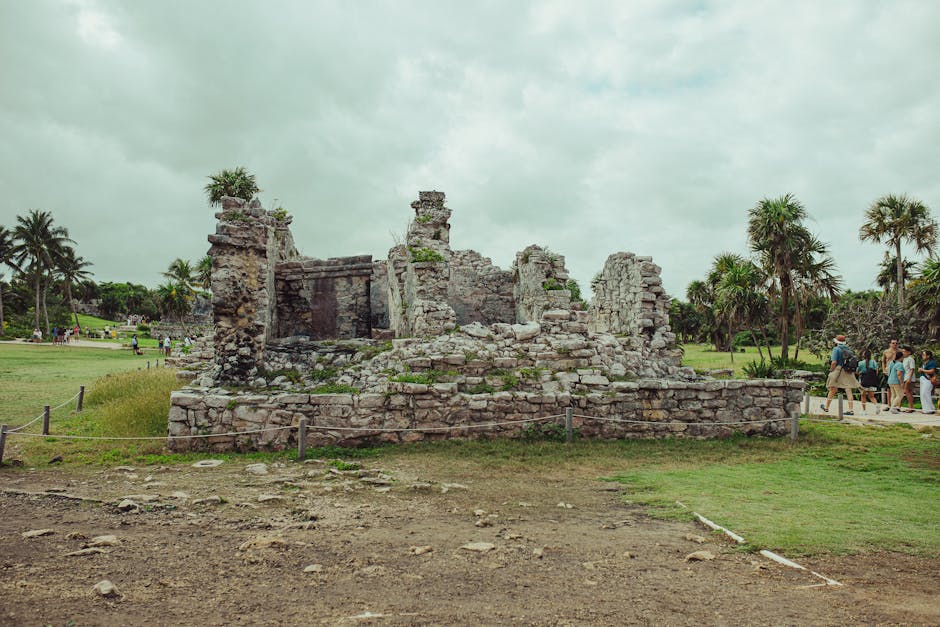 best time of year to visit mayan ruins - Explore the ancient Mayan ruins in Tulum, Mexico, set against lush greenery and a cloudy sky.