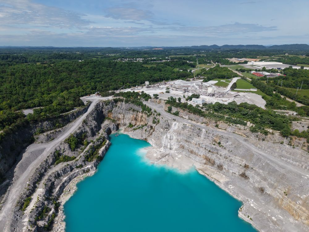 Aerial view of a limestone quarry with turquoise water — photo by Betty Krachey on Pexels