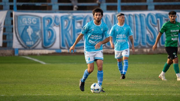 Soccer match capturing players in action on the field, vibrant jerseys.