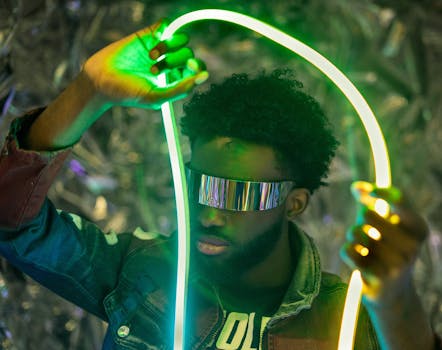 Man with futuristic sunglasses holding neon lights, vibrant colors