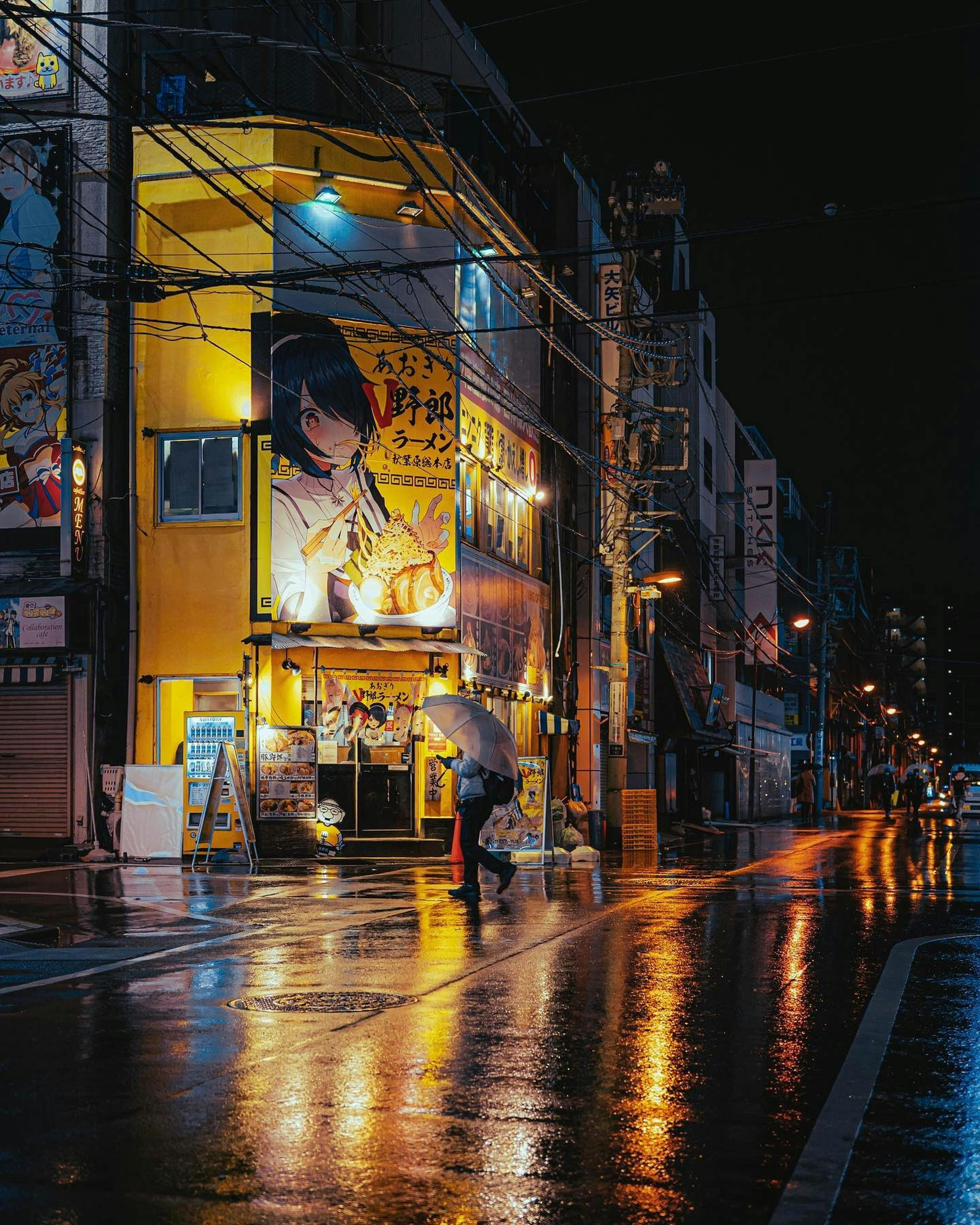 Explore the illuminated streets of Taitō, Tokyo at night with reflections and lively billboards.
