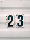 Close-up Of  The Number 23 Sticker On A White Corrugated Surface