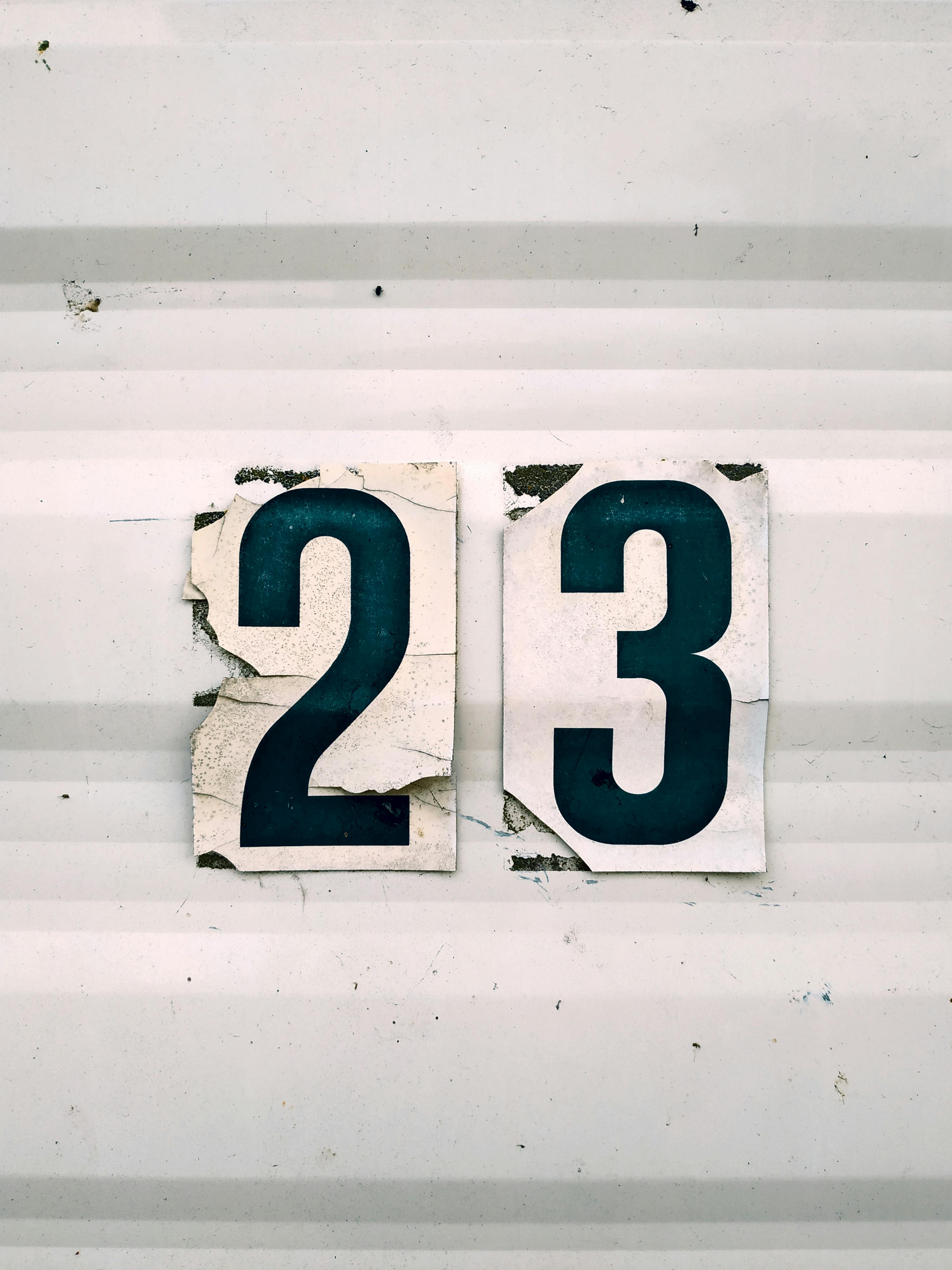 Closeup Of The Number 23 Sticker On A White Corrugated Surface · Free