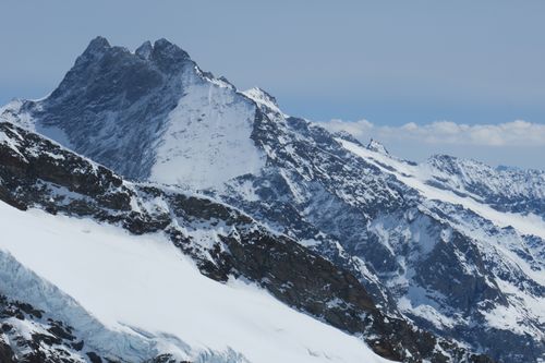 Free Breathtaking view of snow-covered mountain peaks under a clear blue sky. Stock Photo