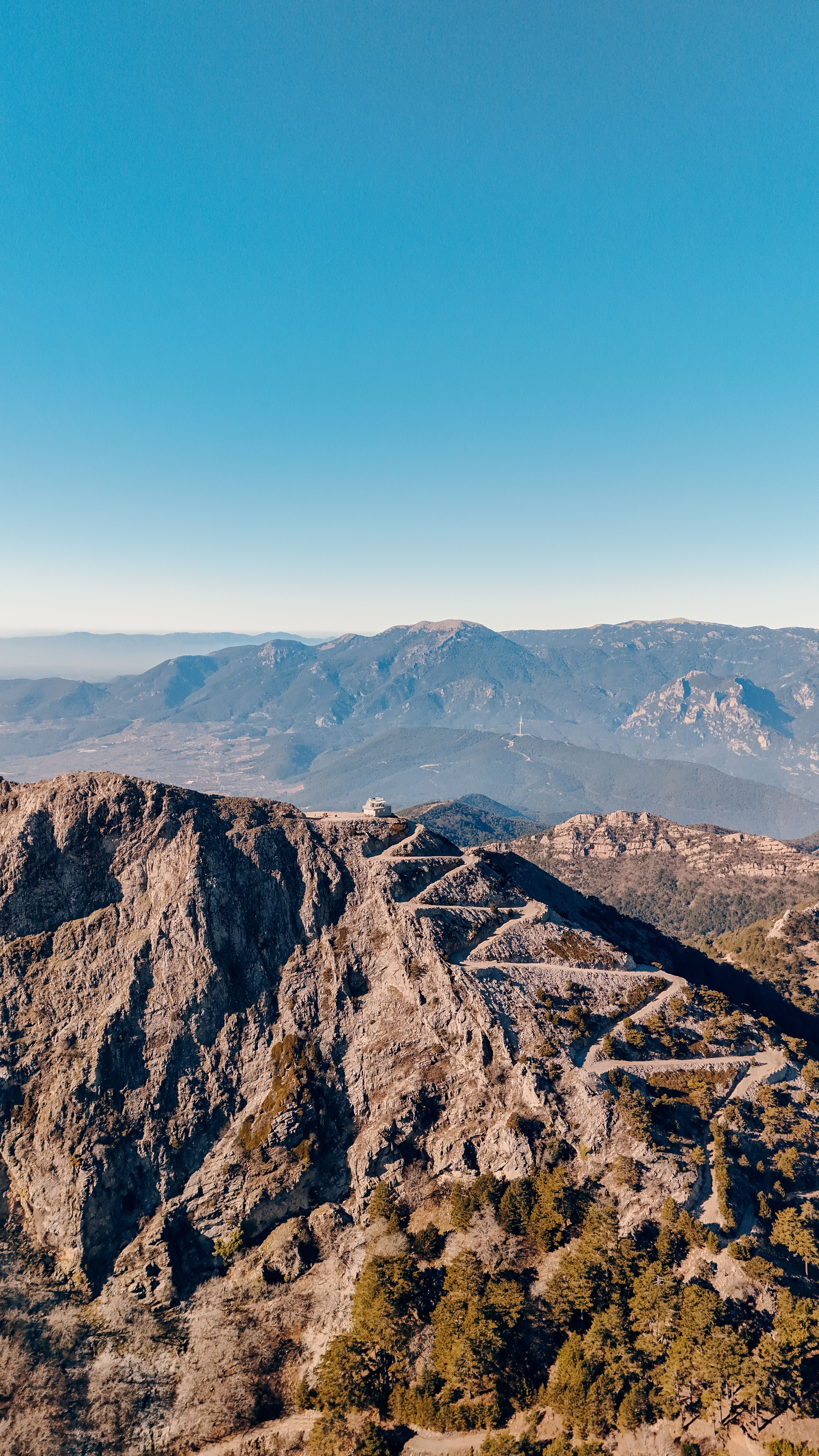 Explore the breathtaking aerial view of the rugged mountains near İzmir, Türkiye, at sunset.