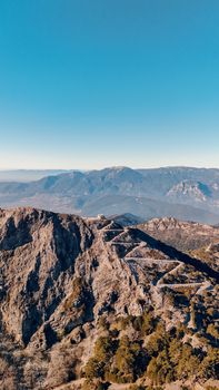 Explore the breathtaking aerial view of the rugged mountains near İzmir, Türkiye, at sunset.