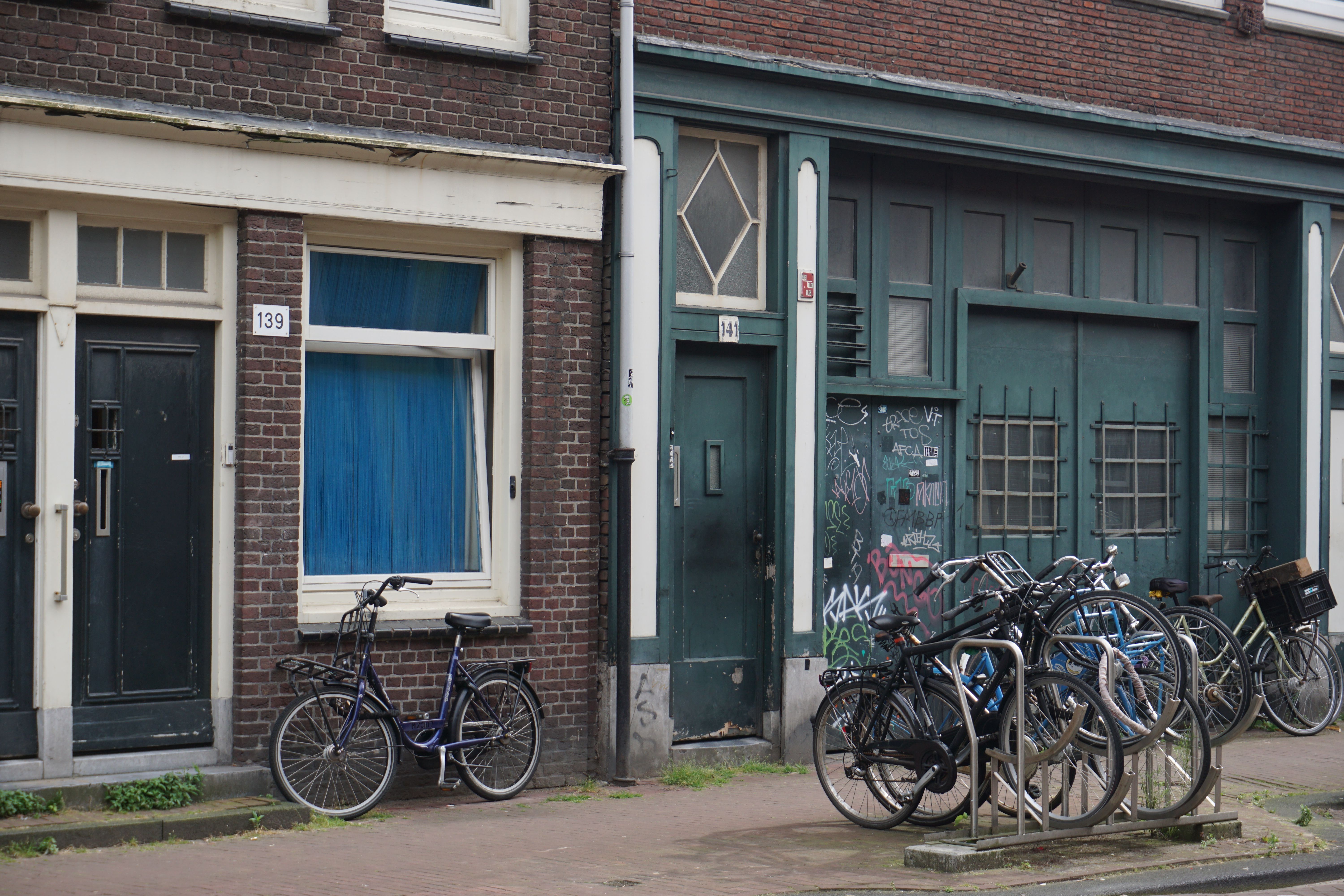 Amsterdam Street Scene with Bicycles and Urban Graffiti · Free Stock Photo