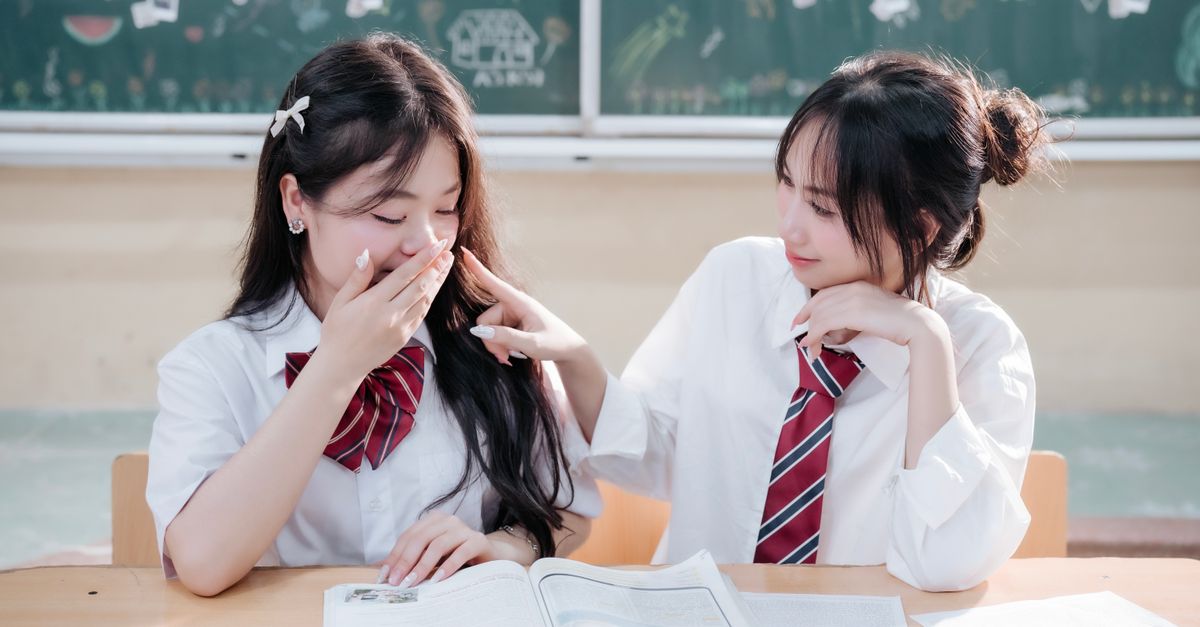 Two Learners Two Students Sharing a Light Moment in Classroom · Free Stock Photo