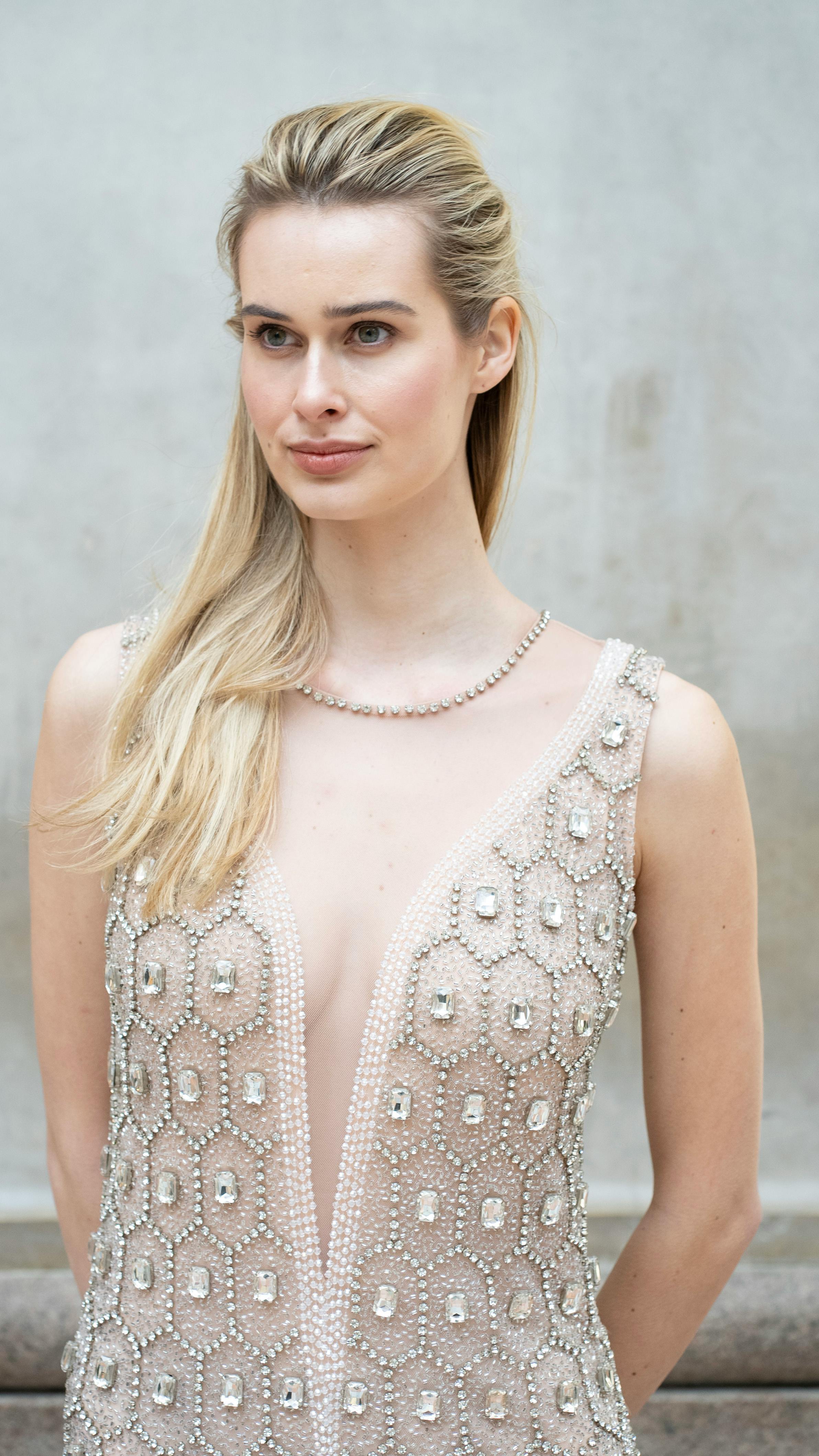 Stylish portrait of a young model in an elegant gown, captured outdoors in Milan.