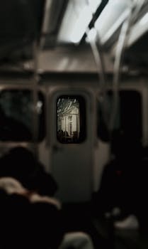 Moody interior of a train with focus on the distant lit section, creating a mysterious ambiance.
