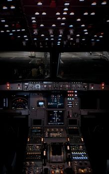 Dimly lit airplane cockpit showcasing a detailed instrument panel during night operations.