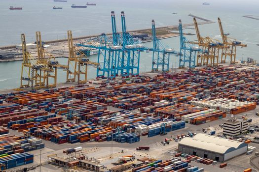 A bustling port with shipping containers and cranes, showcasing global trade.