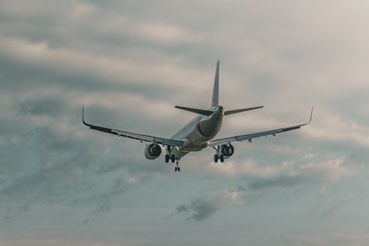 Airplane flying against a cloudy sky, capturing aviation dynamics.