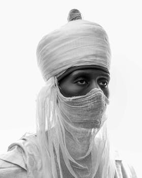 A captivating black and white portrait of a person in traditional attire with a serene expression.
