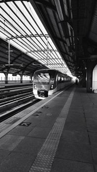 Monochrome view of a modern train at a station in Thailand, showcasing urban transit.