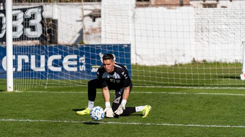 Free A goalkeeper in action making a save on a sunny day during a soccer match. Stock Photo