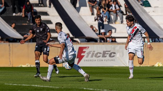 Action-packed soccer match scene with players in motion on the field.
