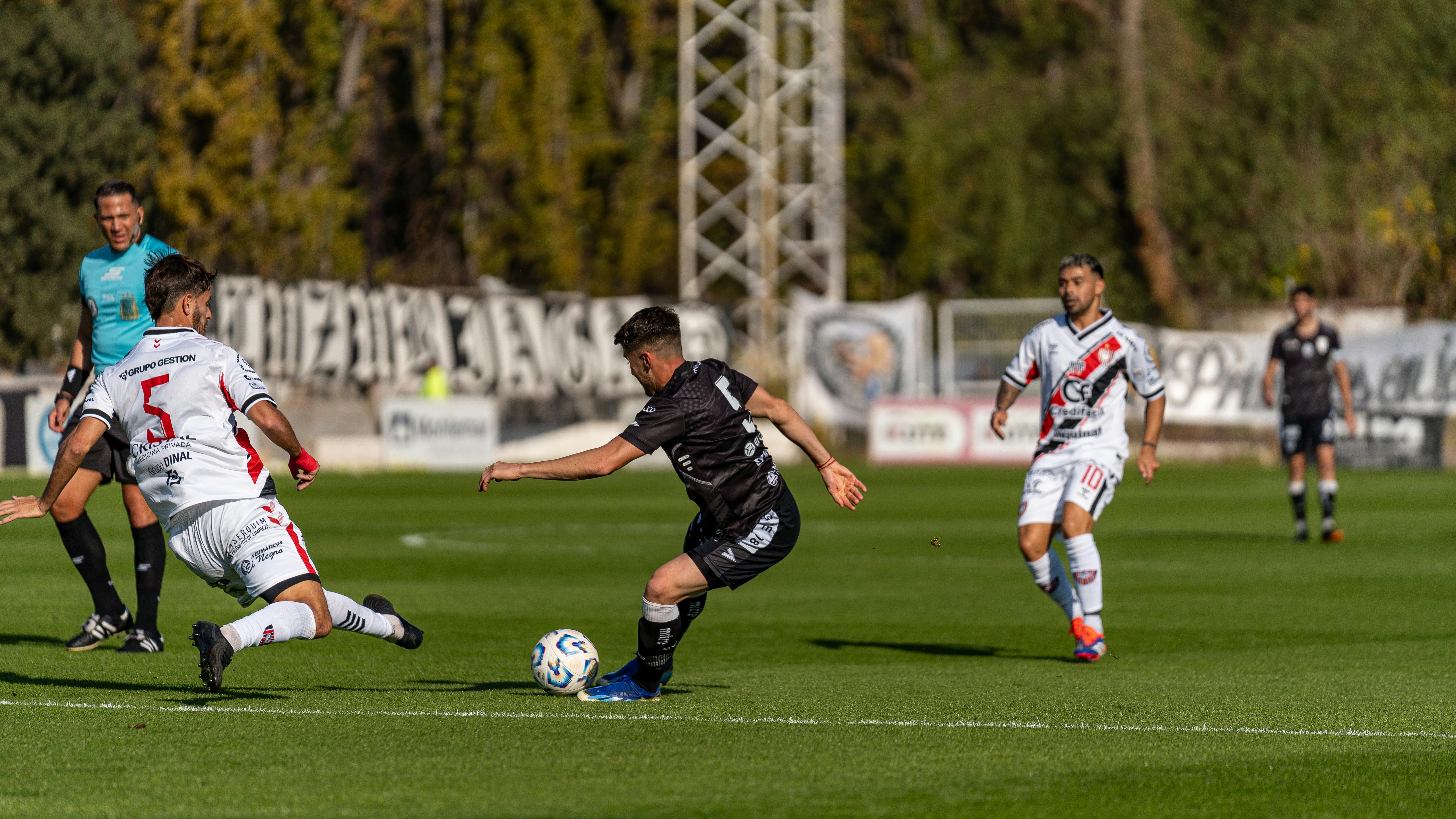 Intense soccer match moment as players compete on the field.