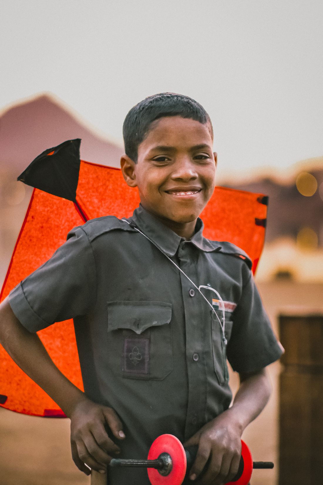 Happy child celebrating Makar Sankranti while holding a colorful kite in India